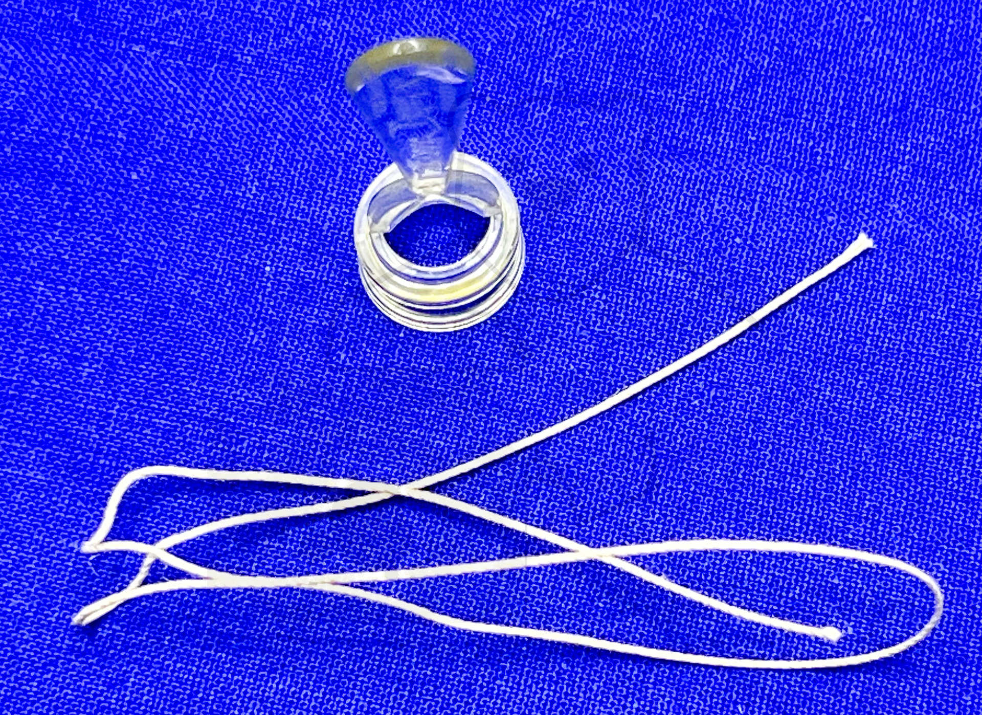 Plastibell, Vorderansicht mit der Schnur, mit der die Vorhaut abgebunden wird